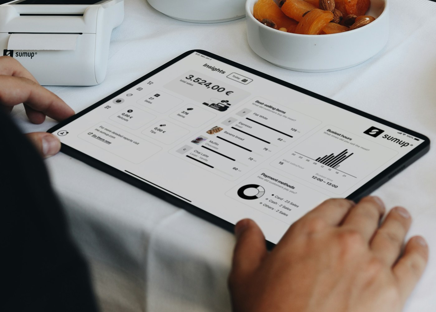 Waiter taking an order on a tablet POS at the table